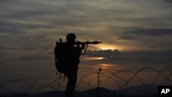 FILE - A Pakistani border security guard stands alert at Pakistan-Afghanistan border post, Chaman in Pakistan. 