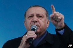 Turkey's President Recep Tayyip Erdogan gestures as he delivers his speech, during a rally for the upcoming referendum, in his hometown city of Rize, in the Black Sea region, Turkey, Monday, April 3, 2017.