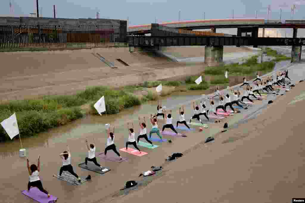 People practice yoga at the Rio Grande at the border between Mexico and U.S, in Ciudad Juarez, Mexico, Sept. 15, 2019.