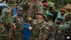 FILE - U.S. Army special forces Master Sergeant speaks with troops from the Central African Republic and Uganda, where U.S. special forces have paired up with local troops and Ugandan soldiers to seek out Joseph Kony's LRA, in Obo, Uganda.