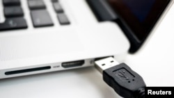FILE - USB devices such as mice, keyboards and thumb-drives can be used to hack into personal and public computers.