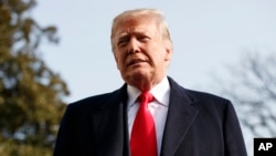 FILE - President Donald Trump pauses as he talks to media before boarding Marine One on the South Lawn of the White House in Washington, Dec. 8, 2018.