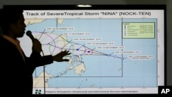 Filipino weather specialist Benison Estareja shows the track of Tropical Storm Nock-Ten during a press conference in Quezon city, north of Manila, Philippines, Dec. 23, 2016. 
