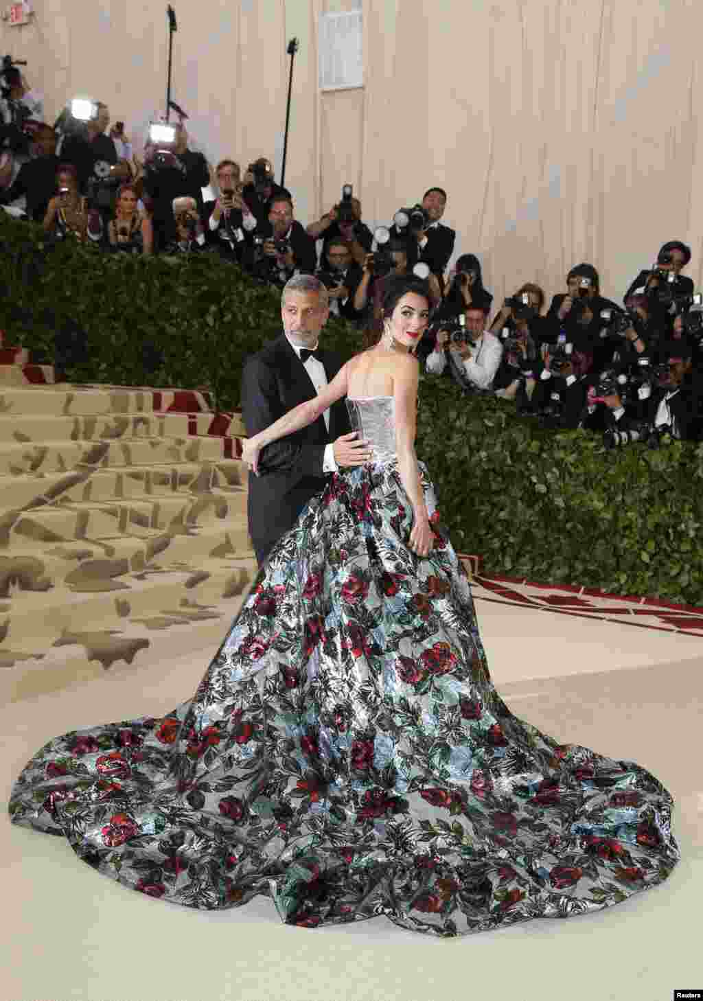 George and Amal Clooney arrive at the Metropolitan Museum of Art Costume Institute Gala (Met Gala) to celebrate the opening of “Heavenly Bodies: Fashion and the Catholic Imagination” in the Manhattan neighborhood of New York City. (REUTERS/Carlo Allegri)