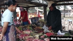 Residents buy/sell meat at open market.