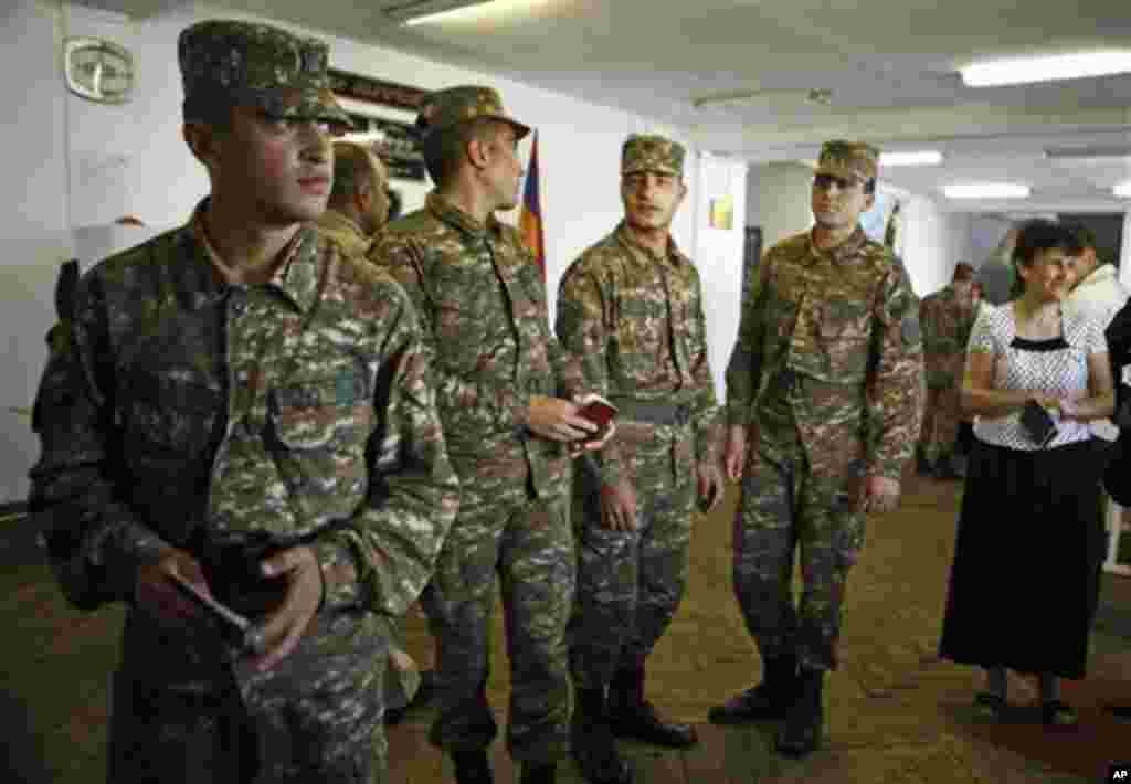 Armenian soldiers queue to cast their ballots, during parliamentary elections in Yerevan, Armenia on Sunday, May 6, 2012. (AP Phoro /PanARMENIAN , Vahan Stepanyan)