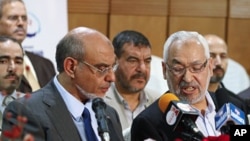 Rachid Ghannouchi (R), leader of the Islamist Ennahda party, speaks with his secretary-general Hamadi Jbeli (L) during a news conference in Tunis, October 28, 2011