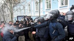 Police use tear gas as they clash with supporters of former Georgian president Mikheil Saakashvili in Kiev, Ukraine, Dec. 5, 2017.