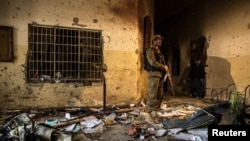 FILE - An army soldier stands inside the Army Public School, which was attacked by Taliban gunmen, in Peshawar, Dec. 17, 2014.