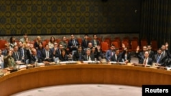 Ambassadors to the U.N. vote during a United Nations Security Council meeting on North Korea in New York City, Sept. 11, 2017. 