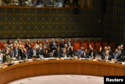 Ambassadors to the U.N. vote during a United Nations Security Council meeting on North Korea in New York City, Sept. 11, 2017.