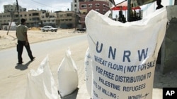 Bags of food aid sit in front of a shop at the Shati refugee camp in Gaza City.