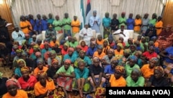 FILE - Nigerian President Muhammadu Buhari meets with 82 freed Chibok schoolgirls in Abuja, Nigeria, May 7, 2017.