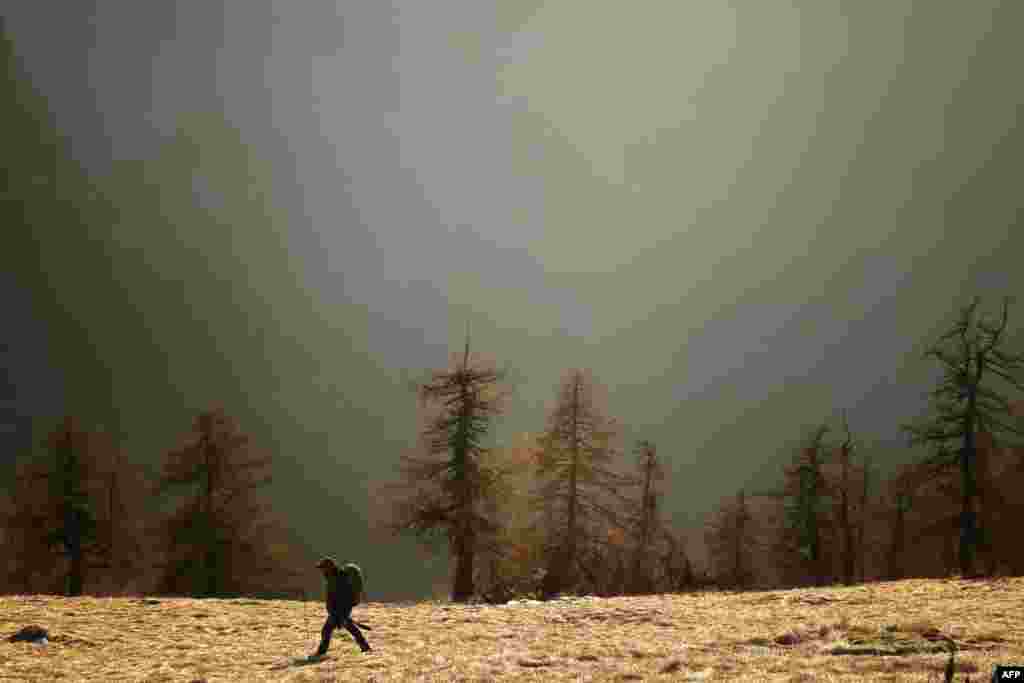 A man walks in the Alps region near Elva, in the Maira Valley, northwest Italy.