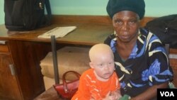 Enipher Foster of Chiradzulu district says the kidnappings has forced her to carry her granddaughter whereever she goes. (Lameck Masina for VOA News)