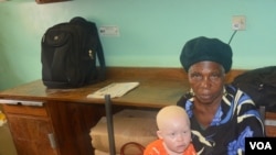 Enipher Foster of Chiradzulu district says the kidnappings has forced her to carry her granddaughter whereever she goes. (Lameck Masina for VOA News)