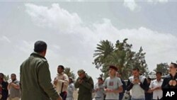 New recruits train and learn how to use weapons after signing up to join the rebel forces, at a training base in Misrata, Libya, April 26, 2011