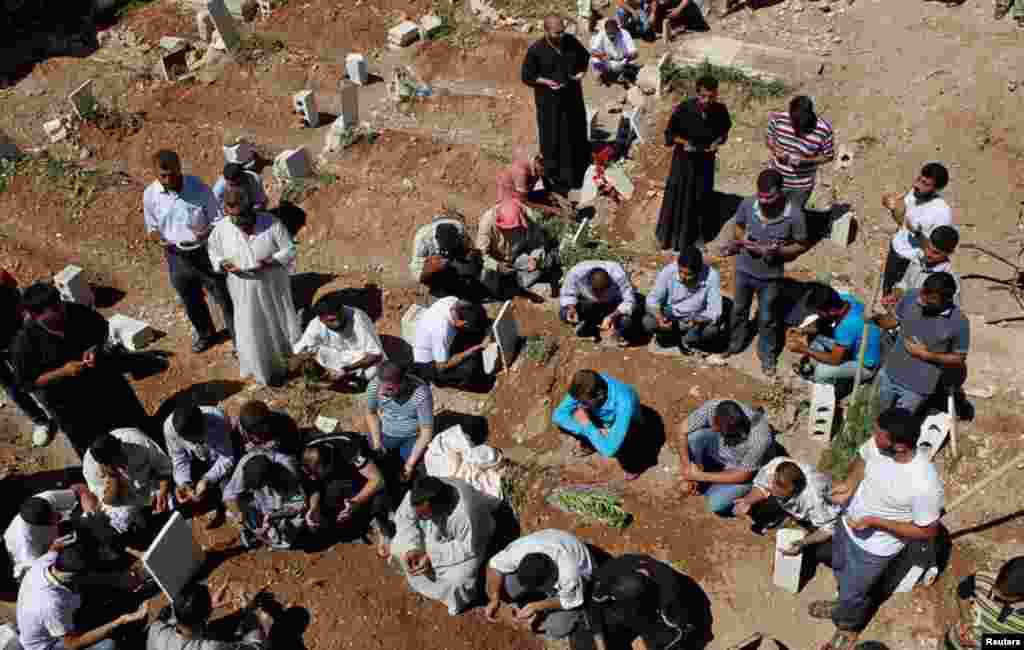 People pray during the funeral of the Free Syrian Army fighter Amar Ali Amero in Azaz, August 21, 2012.