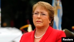FILE- Chile's President Michelle Bachelet applauds as she attends a wreath-laying ceremony in Buenos Aires, Argentina, May 12, 2014. 