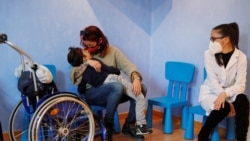 Valentina Perniciaro holds her son Sirio Persichetti, a 7-year-old with spastic tetraplegia and cerebral palsy who has become an influencer by challenging perceptions of disability. REUTERS/Yara Nardi