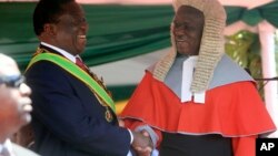FILE: Zimbabwean President Emmerson Mnangagwa,left, is congratulated by Chief Justice Luke Malaba after taking his oath during his inauguration ceremony at the National Sports Stadium in Harare, Sunday, Aug. 26, 2018. 