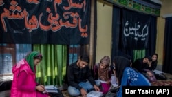 Mohammad Hussain teaches Kashmiri girls in a temporary learning center set up in a building meant for religious activity in Srinagar, Indian controlled Kashmir.