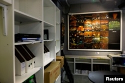 FILE - An exhibition board is pictured at the the June 4th Museum showing the annual turnout of the candlelight vigil in memory of the Tiananmen Square crackdown in 1989, after it was announced that the Hong Kong Alliance in Support of Patriotic Democratic Movements of China group would disband, in Hong Kong, Sept. 25, 2021.