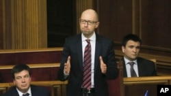 Ukrainian Prime Minister Arseniy Yatsenyuk reacts after surviving a vote of no confidence, in Parliament in Kyiv, Ukraine, Tuesday, Feb. 16, 2016.