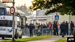 Les éléments de la police encadrent une opération d'évacuation de migrants kurdes d'Irak installés près d'un gymnase, pour les centres d'accueil des migrants, à Grande-Synthe, dans le nord de la France, 24 mai 2018.