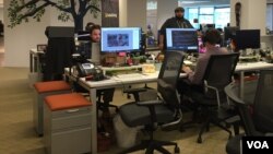 Employees at GlobalGiving at its Washington, DC, office keep the world's first and largest crowdfunding organization open year round. It operates virtually 24/7. (Photo - C. Presutti/VOA). 