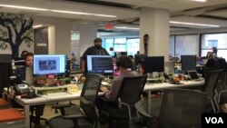 Employees at GlobalGiving at its Washington, D.C., office keep the world's first and largest crowdfunding organization open year round. It operates virtually 24/7. (Photo - C. Presutti/VOA).