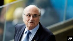 FILE - Fifa President Sepp Blatter waits for the beginning of the World Cup semifinal soccer match between Brazil and Germany at the Mineirao Stadium in Belo Horizonte, Brazil, July 8, 2014.