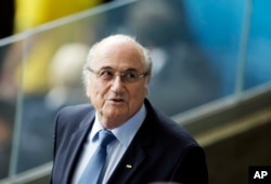 FILE - Fifa President Sepp Blatter waits for the beginning of the World Cup semifinal soccer match between Brazil and Germany at the Mineirao Stadium in Belo Horizonte, Brazil, July 8, 2014.