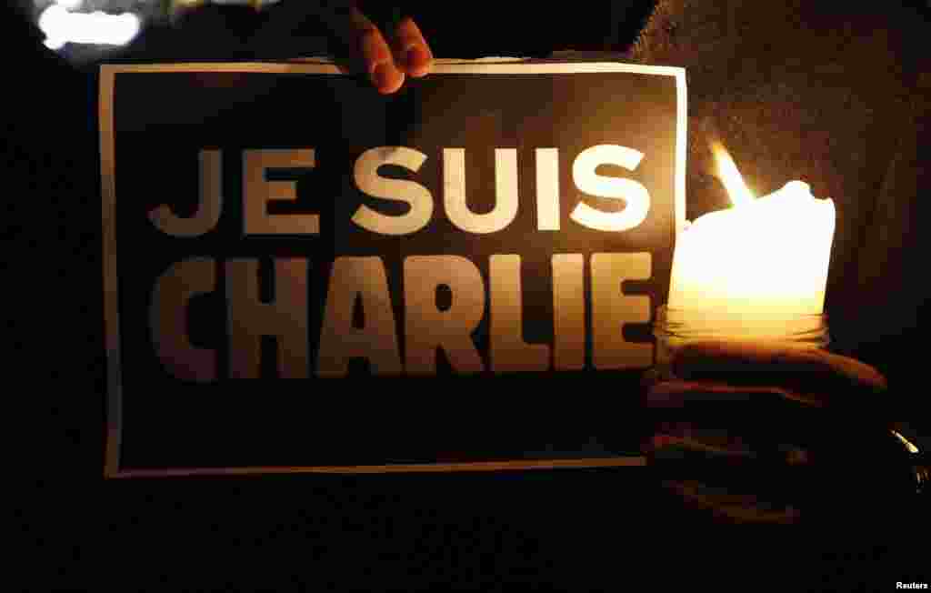 A person holds a placard that reads &quot;I am Charlie&quot; to pay tribute during a gathering in Strasbourg, France, following a shooting by terrorists at the offices of the weekly satirical Charlie Hebdo in Paris, Jan. 7, 2015.