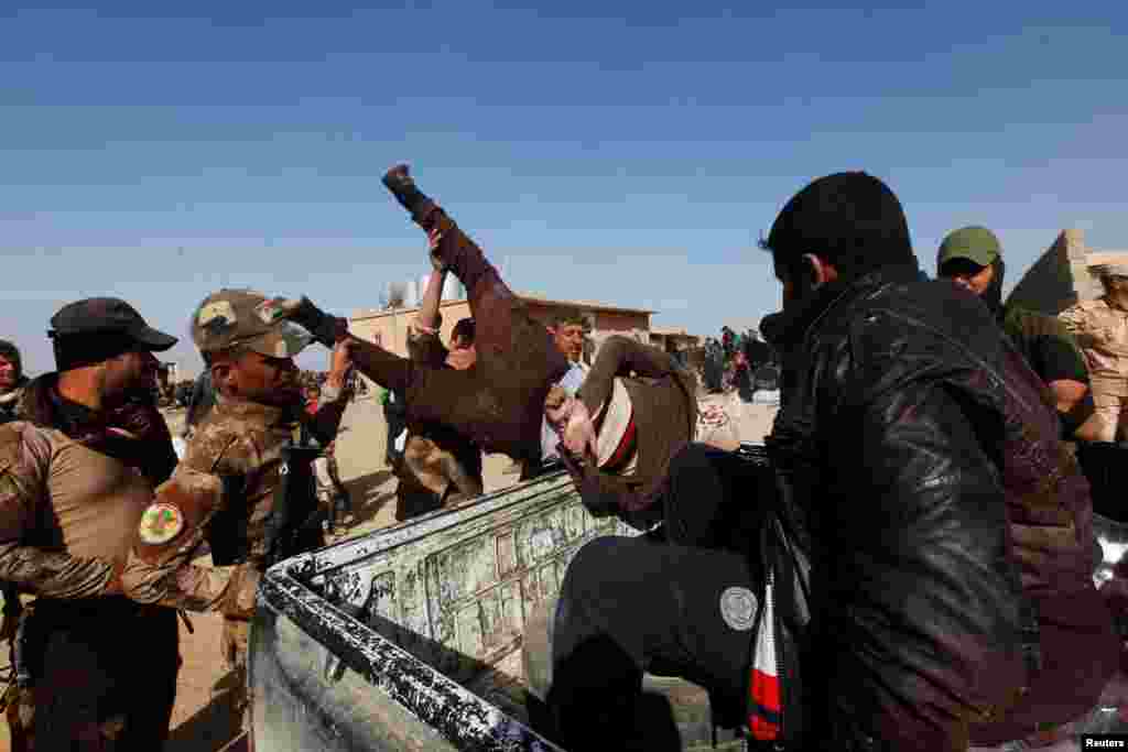 Iraqi Special Operations Forces arrest a person suspected of belonging to Islamic State, in western Mosul.