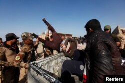 Iraqi Special Operations Forces arrest a person suspected of belonging to Islamic State militants in western Mosul, Iraq, Feb. 26, 2017.