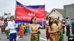 Cambodian traditional dancers give blessing during an annual parade in the designated 'Cambodia Town' section of Long Beach, California, on April 2, 2011, to celebrate Khmer New Year.