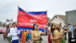 Cambodian traditional dancers give blessing during an annual parade in the designated 'Cambodia Town' section of Long Beach, California, on April 2, 2011, to celebrate Khmer New Year.