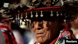 FILE - A Huichol elder, wearing a traditional hat, takes part in a protest in Mexico City, Oct. 27, 2011, against the construction of a silver mine in Wirikuta, one of the Huichol indigenous community's sacred ceremonial sites.