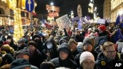 People demonstrate after the Polish parliament approved a bill that is widely viewed as restricting media freedom, in Warsaw, Poland, Dec. 19, 2021. 