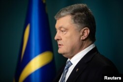 FILE - Ukraine's President Petro Poroshenko delivers a televised address after Russian authorities moved to simplify the process of obtaining Russian citizenship for Ukrainians living in areas controlled by Russia-backed separatists in eastern Ukraine, in Kyiv, April 24, 2019.