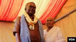 Phok Se, 77, Kem Ley's mother, stands next to a statue of her son in Takeo province, Cambodia, Sunday, October 15, 2016. (Leng Len/VOA Khmer)