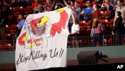 Protesters unfurl a sign in the upper deck of Busch Stadium during the second inning of a baseball game between the St. Louis Cardinals and the Milwaukee Brewers, Sept. 29, 2017, in St. Louis. Protests have continued two weeks after former St. Louis police officer Jason Stockley was acquitted in the 2011 killing of a black man following a high-speed chase. 