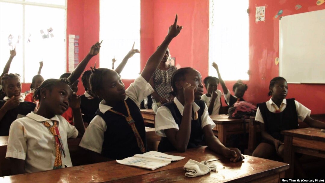 Students seek attention at the More Than Me Academy in Monrovia, Liberia.