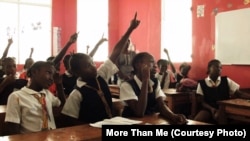 Students seek attention at the More Than Me Academy in Monrovia, Liberia.