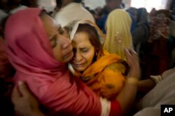 Pakistani Christian women mourn the deaths of their family members during a funeral service at a local church in Lahore, Pakistan, March 28, 2016.