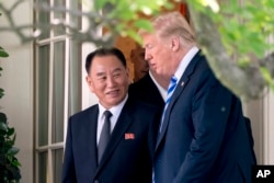 President Donald Trump talks with Kim Yong Chol, former North Korean military intelligence chief and one of leader Kim Jong Un's closest aides, as they walk from their meeting in the Oval Office of the White House in Washington, June 1, 2018.