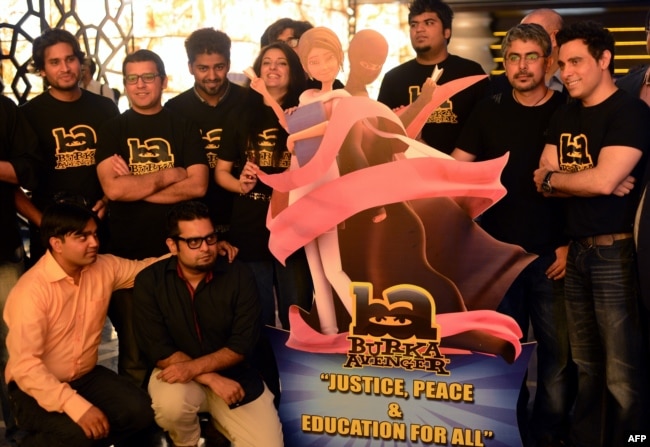 FILE - Aaron Haroon Rashid, one of Pakistan's biggest pop stars (R) poses with his team at the press presentation for the cartoon show "Burka Avenger" in Rawalpindi, Aug. 4, 2013.