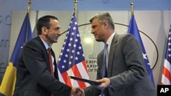 U.S Assistant Secretary of State Philip Gordon shakes hand with Kosovo Prime Minister Hashim Thaci (R) after signing an agreement to support education authorities in capital Pristina, June 16, 2011