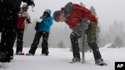 Frank Gehrke, chief of the California Cooperative Snow Surveys Program for the Department of Water Resources, checks the snowpack depth during the manual snow survey at Phillips Station, March 30, 2017, near Echo Summit, Calif. 